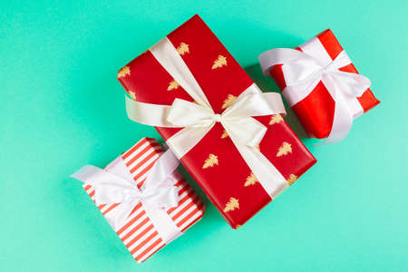 Decorated gift box on a green background, flat lay top viewの写真素材