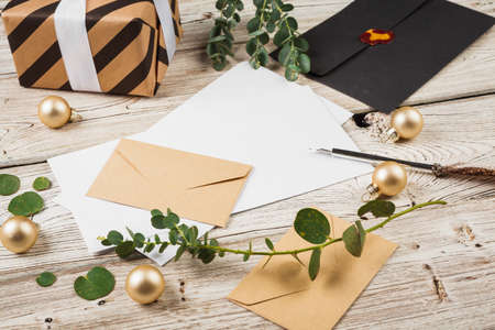 Vintage style composition with weathered paper and quill pen on wooden table close upの写真素材