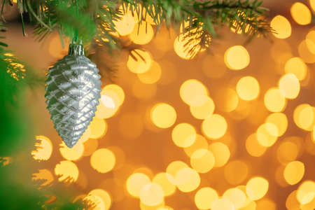 Christmas tree background with grey bauble on golden bokeh sparklingの写真素材