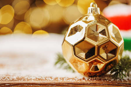 Snowy table with christmas bauble decoration close upの写真素材