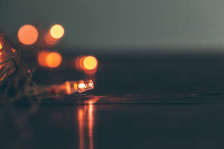 Illuminated garland close up on dark backgroundの写真素材