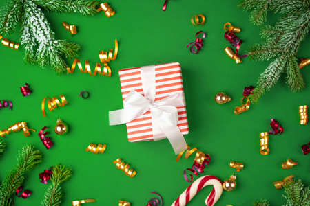 Top view of wrapped present on a green festive backgroundの写真素材