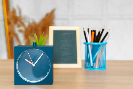 Office interior details with alarm clock and stationery itemsの写真素材
