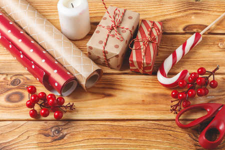 Christmas wrapping and decorating items on wooden background with copy spaceの写真素材