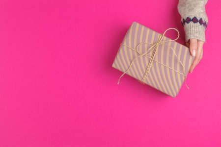 Small gift box in female hands, view from aboveの写真素材