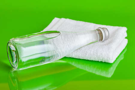 Crystal clear water in a bottle on green background