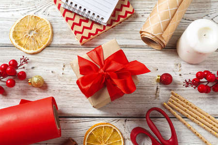 Christmas decorations and gift wrapping items on wooden background, copy spaceの写真素材