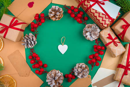 Craft christmas gifts with red ribbons on decorated christmas backgroundの写真素材