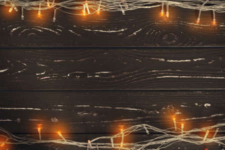 Christmas garland on wooden background with copy space