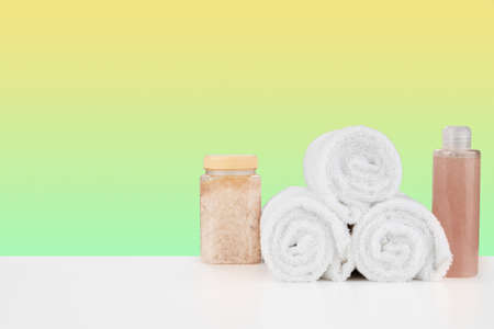 Bath towels and spa salt on white tableの写真素材