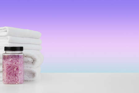 Bath towels and spa salt on white tableの写真素材