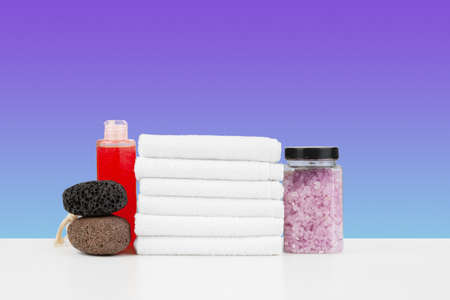 Bath towels and spa salt on white tableの写真素材