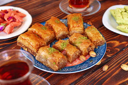 Turkish sweet baklava with Turkish tea on wooden backgroundの写真素材