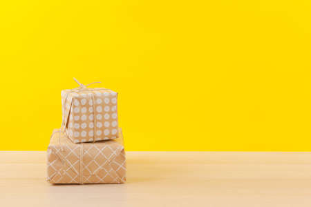 Gifts with ribbons on bright yellow backgroundの写真素材
