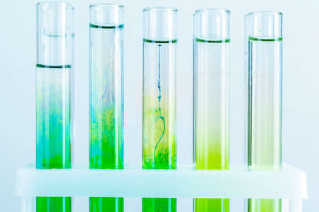 Green liquids in test tubes in chemical laboratory close upの写真素材