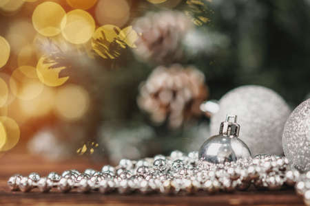Xmas baubles on wooden table on bokeh backgroundの写真素材