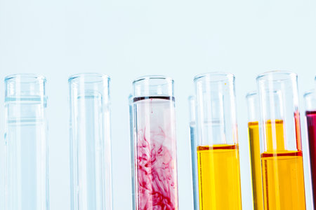 Different laboratory glassware with colored liquids close upの写真素材