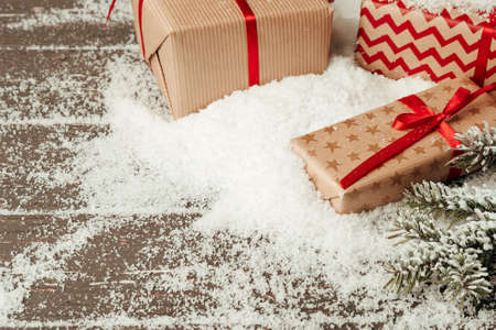 Snowy composition with Christmas gift on wooden tableの写真素材