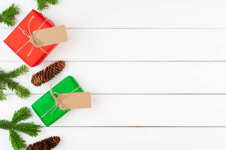 Christmas gift with spruce branches on wooden backgroundの写真素材