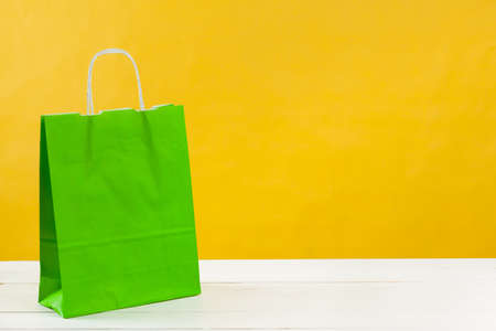 Paper shopping bags on bright yellow backgroundの写真素材