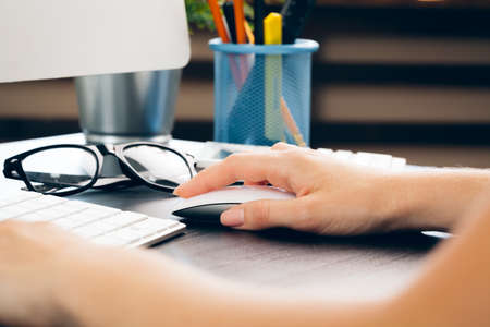 Business woman at work with laptop close upの写真素材