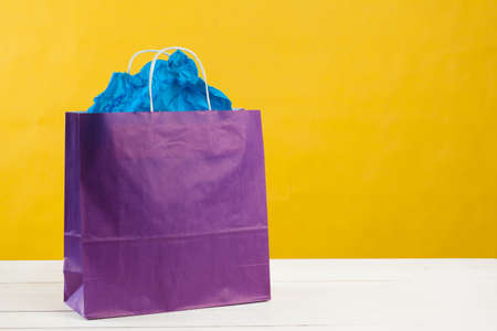 Arrangement of shopping bags on bright yellow backgroundの写真素材