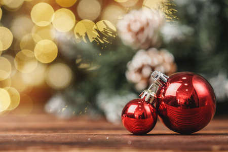 Xmas baubles on wooden table on bokeh backgroundの写真素材