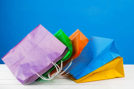 Paper shopping bags with copy space on blue backgroundの写真素材
