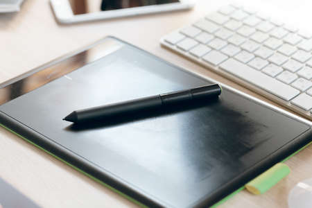 Close up of graphic tablet with pen for illustrators and designers in an officeの写真素材
