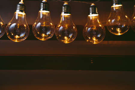 Garland of light bulb lamps in the darkの写真素材