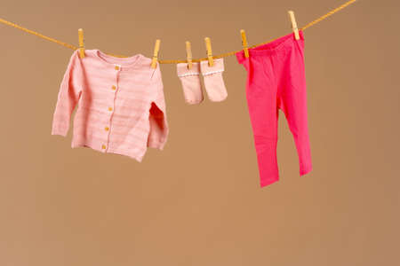 Kids apparel pinned to a clothesline to dryの写真素材