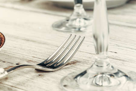 Close up shot of table setting for fine dining with cutlery and glasswareの写真素材