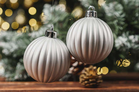Christmas decorative balls against blurred pine tree backgroundの写真素材