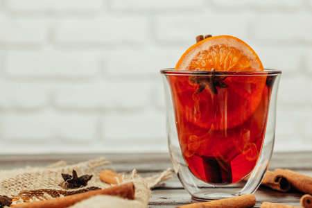 Close up of mulled wine cup with spices and berries on grey tableの写真素材