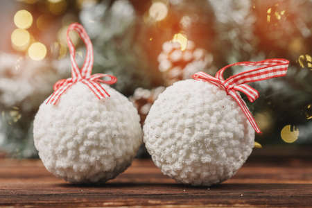 Christmas decorative balls against blurred pine tree backgroundの写真素材