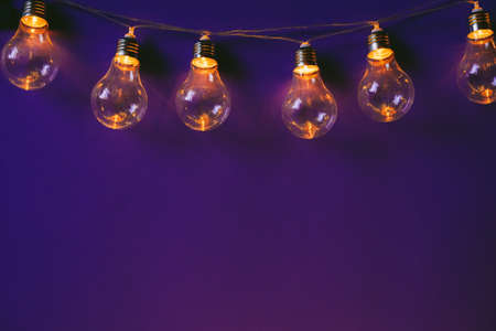 Beautiful illuminated festive light bulbs garland close upの写真素材