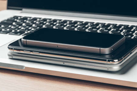 Laptop and mobile phone on the table. Workspace concept.の写真素材