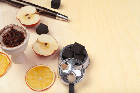 Parts of hookah and fruits on wooden backgroundの写真素材