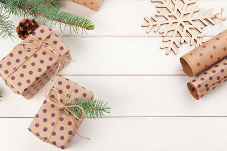 Gifts wrapped with craft paper on white wooden tableの写真素材