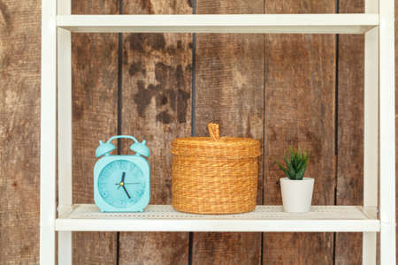 Close up of white bookshelf against grunge wooden wallの写真素材