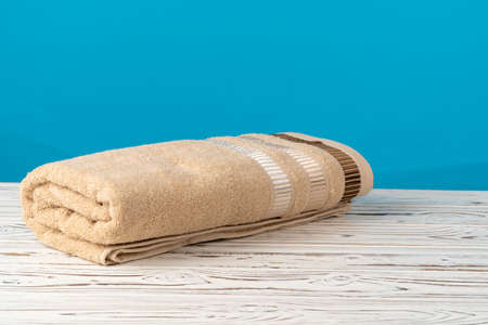 Pile of clean new towels against grey wallの写真素材