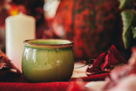 Autumn decor with pumpkin, candles and tablewareの写真素材