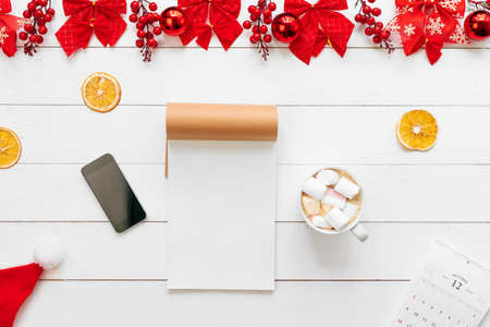Office table with devices, supplies and christmas decor. View from aboveの写真素材