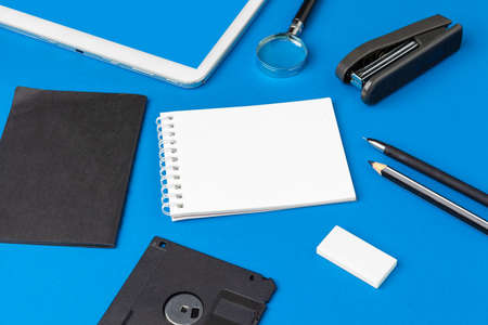 Flat lay, top view of blue office table desk. Workspace with blank note book, office suppliesの写真素材
