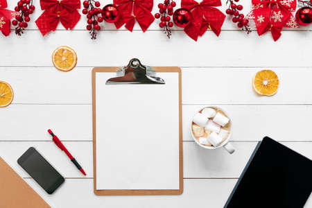 Office table with devices, supplies and christmas decor. View from aboveの写真素材
