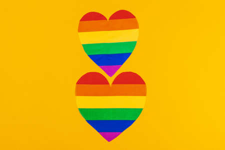 Rainbow paper heart on paper background top viewの写真素材