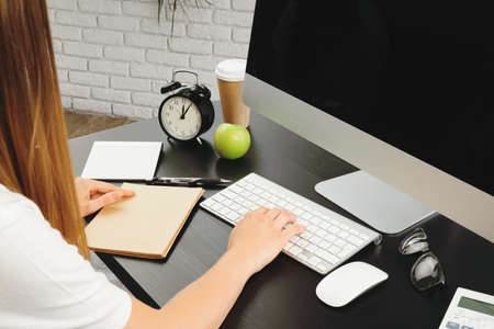 Businesswoman using her computer at an office or at homeの写真素材