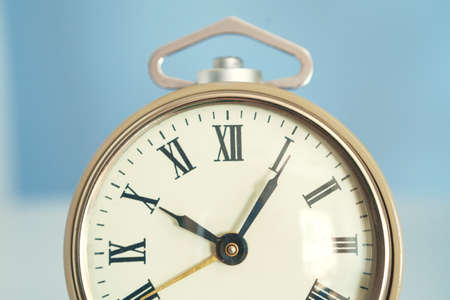 Close up of vintage alarm clock on wooden tableの写真素材