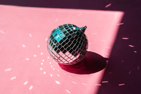 disco ball bauble on pink background. party conceptの写真素材