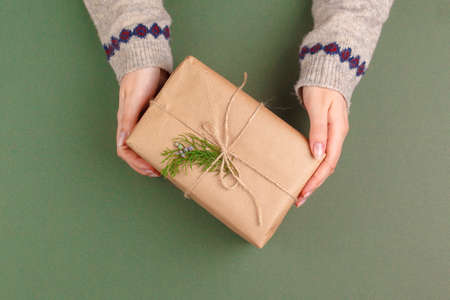 beautiful gift box wrapped in holiday paper with bow, top viewの写真素材